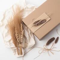 Top View of Rustic Style Gift Box, Burlap Thread and Dried Grain Grass on White Crumpled Paper Background. . photo