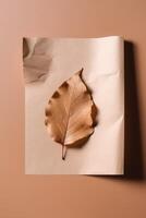 Blank Kraft Paper Mockup and Dry Leaf on Brown Background. . photo