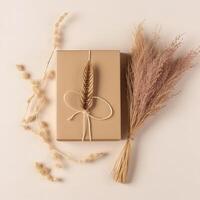 Top View of Rustic Style Packed Gift Box with Burlap Thread, Dried Grass on Beige Background, . photo