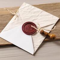 Overhead View of Red Wax Sealed White Old Letter Envelope with Stamp on Wooden Table. . photo