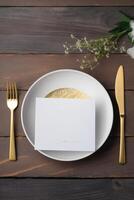 Top view of Dining Table with Blank White Invitation Card, Gypsophilaon Flower on Brown Wooden Background. Party or Wedding Vertical Template Design. . photo