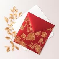 Top View of Elegance Invitation Card, Envelope decorated with Golden Flower and Leaves for Wedding or Event Concept. . photo