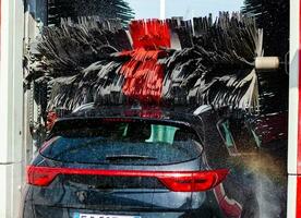 Black car in automatic car wash photo