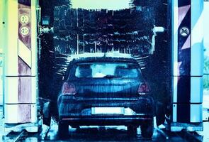 Black car in automatic car wash photo