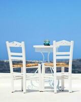 Two white chairs in santorini photo