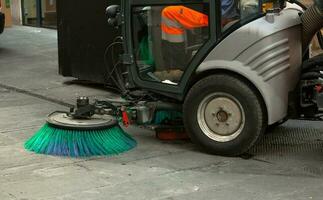 Street sweeper machine cleaning the streets photo