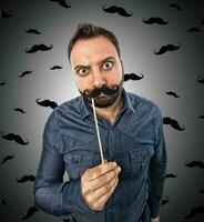 Young man with photo booth shaped mustache