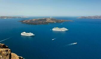 cruise ship near volcano on island of Santorini photo