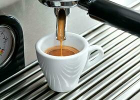 Espresso machine making a cup of coffee. photo