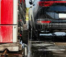 Black car in automatic car wash photo