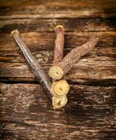 Licorice roots on rustic table. photo