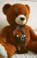 Teddy bear with vintage 35mm camera photo