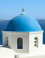 Traditional blue cupola in Oia, Santorini photo