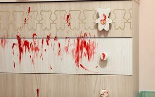 Chest of drawers all dirty with red paint. photo