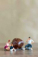 Miniature people Happy family enjoying chocolate photo