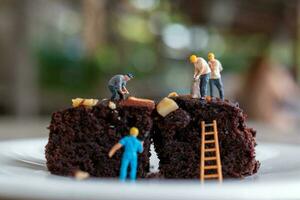 Miniature people, An employee is making a chocolate brownie photo