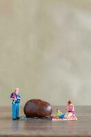 Miniature people Happy family enjoying chocolate photo