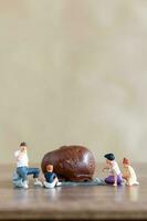 Miniature people Happy family enjoying chocolate photo