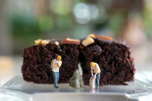 Miniature people, An employee is making a chocolate brownie photo