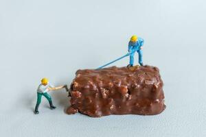 Miniature An employee is making a chocolate bars on gray background. World Chocolate Day Concept photo