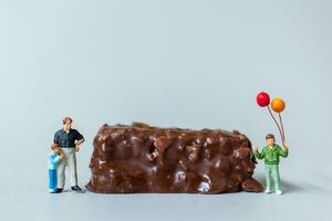 Kids with chocolate bars standing on gray background. World Chocolate Day Concept photo