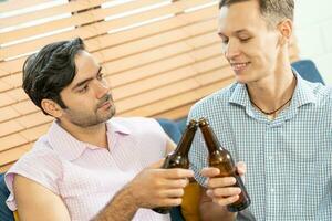 Gay Couple Love Home Concept. Gay Couple Kissing. gay couple in love with beer. photo