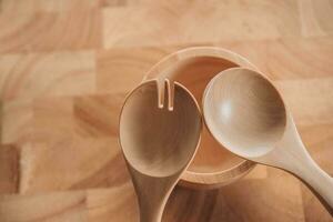 hand holding fork and wooden spoon photo