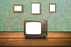 Old Television on wooden floor and photo frames on wall