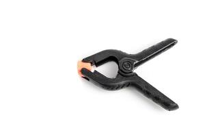 Pair of black clamp with orange plastic jaws, isolated over the white background photo