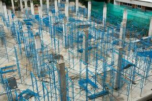 Build construction with steel scaffolding around raw structure. photo