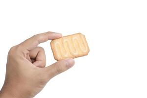 Hand holding a cracker on white background. Clipping path photo