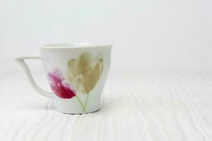 Tea cup on white wooden photo