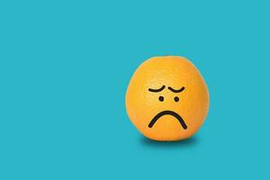 Orange face sad on blue background photo