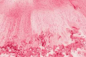 Spread-out acrylic paint. Abstract background, made in the technique of fluid art. Demonstrating the colors of 2023 - Viva Magenta photo