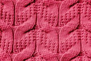 Beautiful handmade knitted repeating pattern. Demonstrating the colors of 2023 - Viva Magenta. photo