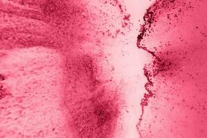 Spread-out acrylic paint. Abstract background, made in the technique of fluid art. Demonstrating the colors of 2023 - Viva Magenta photo