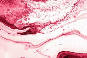 Spread-out acrylic paint. Abstract background, made in the technique of fluid art. Demonstrating the colors of 2023 - Viva Magenta photo