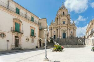 Ragusa, Italy-May 8, 2022-View of the cathedral of San Giorgio in the cathedral square during a sunny day photo