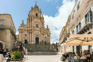 Ragusa, Italy-May 8, 2022-View of the cathedral of San Giorgio in the cathedral square during a sunny day photo