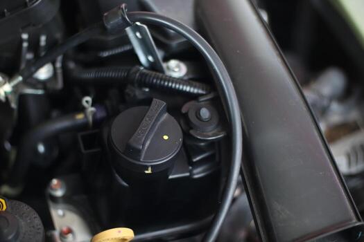 selective focus on the Engine oil cap installed on a car engine for maintenance service lubricant, automotive part concept. soft focus photo