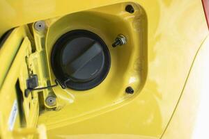 selective focus on the yellow car fuel tank cover with a warning using octane fuel number 92. soft focus photo