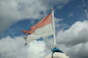 the Indonesian flag is red and white which is shabby, torn and faded photo