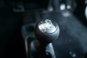 selective focus to manual stick shift car transmission with 5 speed. soft focus. under exposure photo