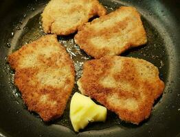 breaded wiener schnitzel with side dishes photo