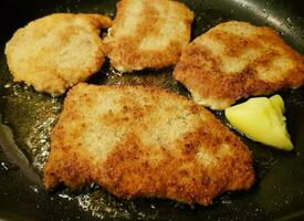 breaded wiener schnitzel with side dishes photo