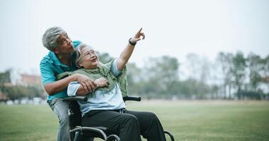 Mature asian couple relax with happy in park photo