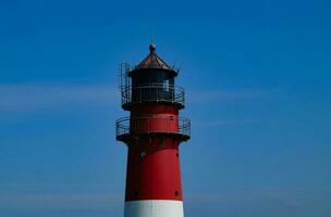 Buesum is a village at the German northern sea with harbor and lighthouse photo