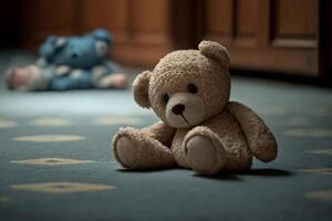 Sad lonely teddy bear lying on the floor symbol of abuse victims photo