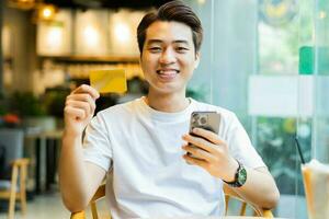 Asian man sitting at coffee shop photo