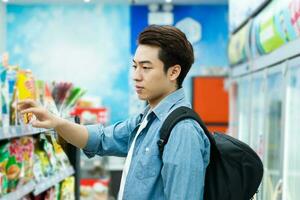 image of Asian man shopping at a convenience store photo